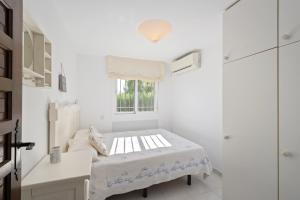 a white room with a bed and a window at Casa May in La Cala de Mijas +19 photos