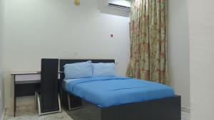 A bed or beds in a room at Prominent Hotel and Suites