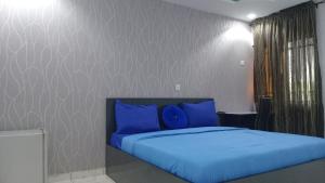 A bed or beds in a room at Prominent Hotel and Suites
