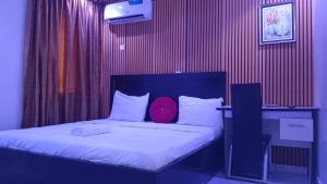 A bed or beds in a room at Prominent Hotel and Suites