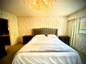 バンクーバーにあるSpacious place Close to UBC -1のシャンデリア付きの大きなベッドのある寝室