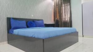 A bed or beds in a room at Prominent Hotel and Suites