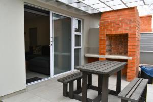 a wooden bench sitting on a patio with a fireplace at Luxury 2 bed York Retreat - Townhouse 3 - 1 on york in George