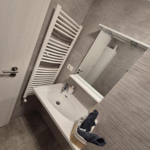 a bathroom with a white sink and a mirror at Studio Palaz in Constanţa
