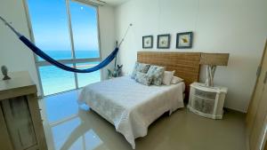 a bedroom with a bed with a view of the ocean at Magico Apartamento Frente al Mar 4 Habitaciones BM63 in Coveñas +45 photos
