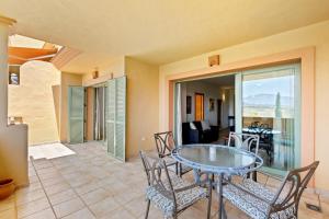 a dining room with a glass table and chairs at Casa Lola Y Suki in Estepona