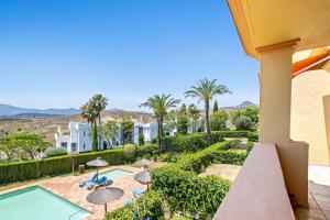 a view from the balcony of a house with a swimming pool at Casa Lola Y Suki in Estepona