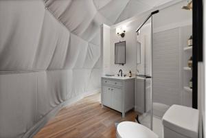 a white bathroom with a sink and a mirror at "Pineview Peak" The Overlook LUX Dome - RRG in Stanton +38 photos