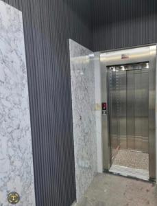 a bathroom with a walk in shower with a door at appart plage in M'diq