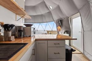 a kitchen with a view of the ocean at "Pineview Peak" The Overlook LUX Dome - RRG in Stanton