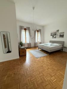 a bedroom with a bed and a wooden floor at Ferienwohnung Klapothek in Leutschach