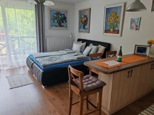 a bedroom with a bed and a desk with a desk at Beatrix apartman in Balatonőszöd