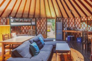 a living room with a couch and a table in a yurt at Terra Perma in Harrington
