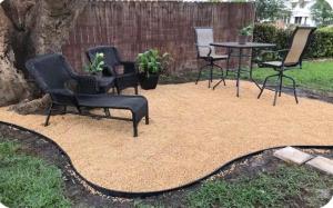 a patio with chairs and a table in a yard at Florida Charm in Pompano Beach