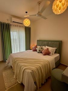 a bedroom with a large bed with pillows on it at Zeleny Santorini in Negombo +77 photos