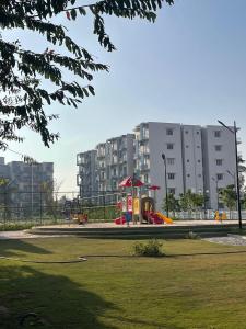 a park with a playground in front of a building at Zeleny Santorini in Negombo +77 photos