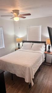 a bedroom with a large bed with a ceiling fan at 3 Bedrooms Florida Sunshine in Pompano Beach