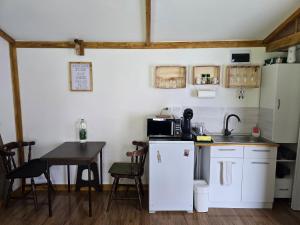 Una cocina con una mesa y un refrigerador blanco. en Cabana Mura,  23 fotos más