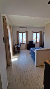 a bedroom with a bed and a table and chairs at Spazio Accogliente dove il tempo si ferma in Livorno