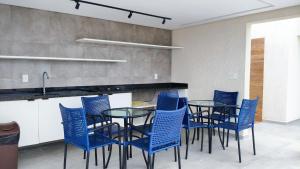 a dining room with blue chairs and a table at Miray Exclusive - Praia dos Carneiros in Praia dos Carneiros