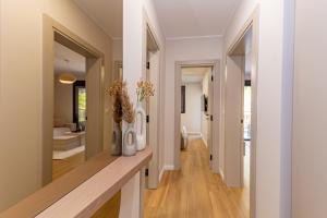 a hallway with a counter with vases and flowers on it at Villa Teona KotorBay Residence in Kotor +193 photos