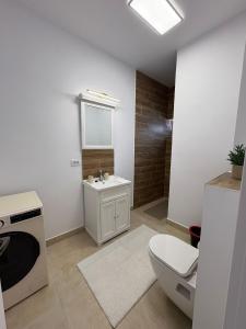 a white bathroom with a toilet and a sink at Studio Felix Relax MAO 13&14 in Baile Felix +16 photos