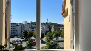 an open window with a view of a parking lot at Apartment Alma - Cosy Stay in Aalborg C in Aalborg