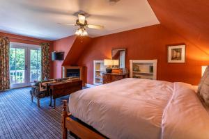 a bedroom with a large bed and a desk at The Jackson in Woodstock
