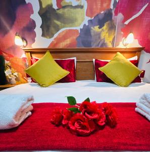 a bedroom with a bed with red roses on it at Liza Luxury Holiday Apartment Oceanic 44 in Durban