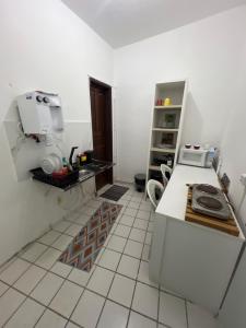 a kitchen with a counter and a machine in it at Manaira Suite 01 in João Pessoa