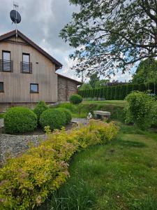 a garden in front of a house with flowers at Sileo Nature in Ustka