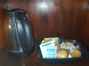 a basket of food on a table with a tea pot at Hostel Trinidad in San Salvador de Jujuy