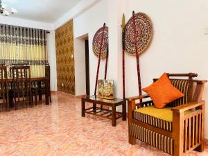 a living room with a couch and a table at Serenity Valley - Tourist Bungalow in Kandy