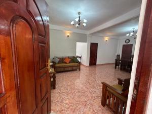 a living room with a couch and a chandelier at Serenity Valley - Tourist Bungalow in Kandy