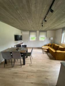 a living room with a table and a couch at Domki pod Wolinem in Wolin