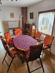 a dining room with a table and four chairs at Give Peace a Chance - 10 km from Sarajevo City Center in Petrovići