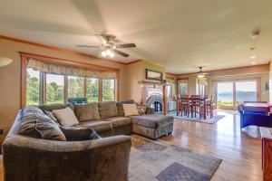 a living room with a couch and a table at Pool Access Waterfront Lake Memphremagog Condo! in Newport