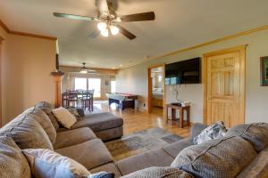 a living room with a couch and a ceiling fan at Pool Access Waterfront Lake Memphremagog Condo! in Newport