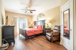 a bedroom with a bed and a chair at Mountain View Condo 3307 in Pigeon Forge +47 photos