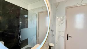 a bathroom with a shower and a large mirror at Free Spirit Sophie in Kalamata +11 photos