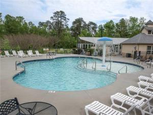 a large swimming pool with chairs and a fountain at Mountain View Condo 3307 in Pigeon Forge