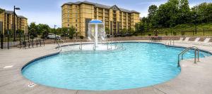 a large pool with a fountain in front of a building at Mountain View Condo 1501 in Pigeon Forge