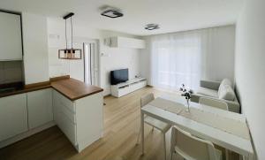 a kitchen and living room with a table and a couch at Casa Buono Holidays in Barano d'Ischia