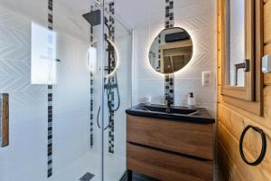 a bathroom with a sink and a mirror at Résidence Pramouton - Chalet Le loup d'Orres MAE-3303 in Les Orres +9 photos