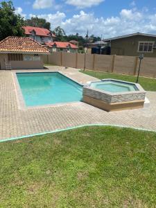 una piscina en un patio al lado de una casa en Palm Springs Apartments, en Couva