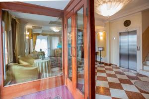 a hallway with a room with a table in it at Hotel Russo Palace in Venice-Lido