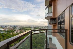 an apartment balcony with a view of the city at The Radiance Manila Bay in Manila
