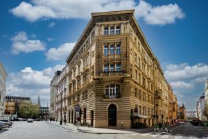 a large wooden building on a city street at Royal Charlie Suite in Prague