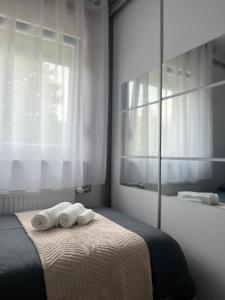 a bedroom with two towels on a bed with a mirror at House Karla in Cerovac Barilovički +63 photos