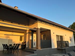 a house with chairs and a table on a patio at House Karla in Cerovac Barilovički